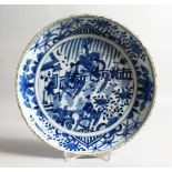 A GOOD CHINESE BLUE AND WHITE CIRCULAR DISH painted with figures and horses. 11ins diameter.