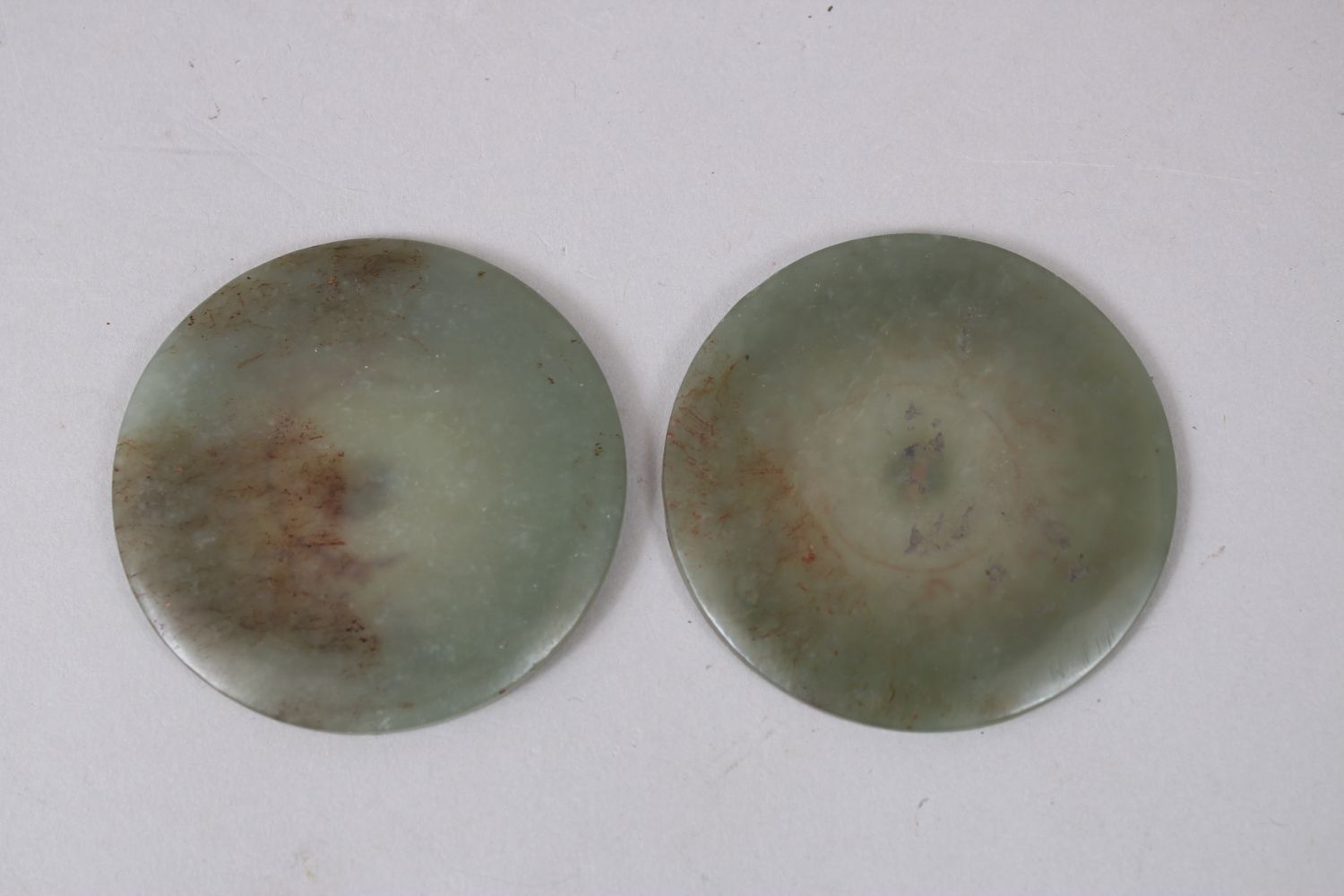 A PAIR OF CHINESE JADE / JADELIKE PENDANTS / BUTTONS, carved decoration, 5.5cm diameter - Image 2 of 2