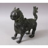 A 19TH-20TH CENTURY PERSIAN PIERCED BRONZE LION INCENSE BURNER, 7ins long.