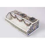 A 19TH CENTURY PERSIAN GLAZED POTTERY INKSTAND with three ink bottles and pen holder, 20cm long.