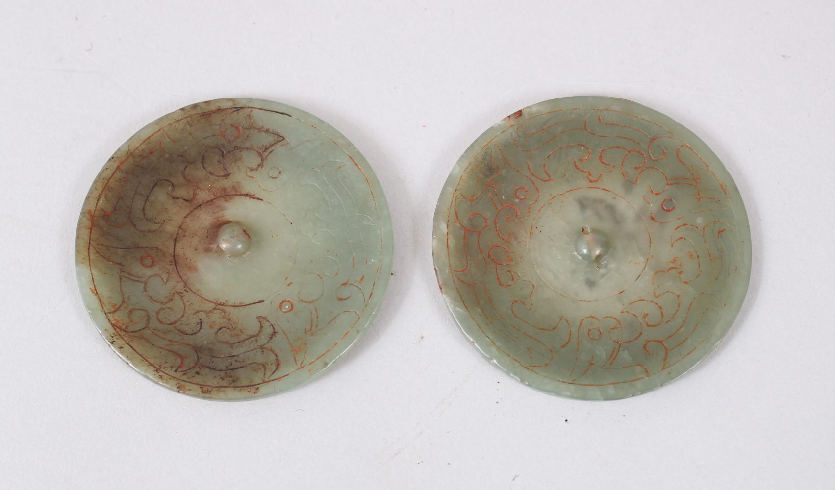 A PAIR OF CHINESE JADE / JADELIKE PENDANTS / BUTTONS, carved decoration, 5.5cm diameter