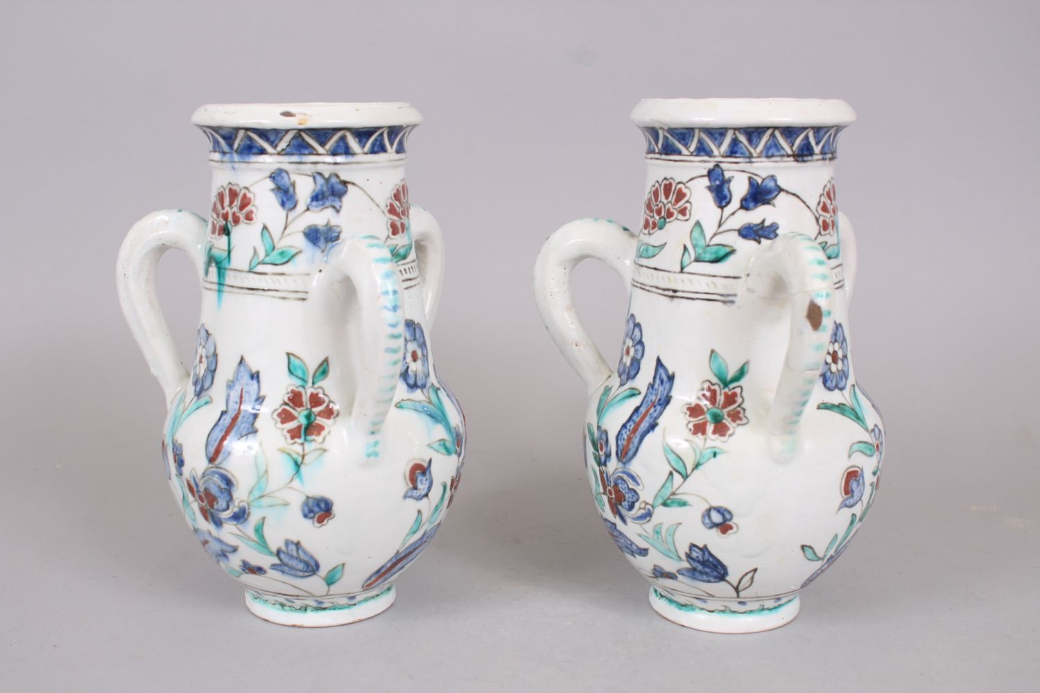 A PAIR OF IZNIK STYLE POTTERY THREE HANDLED VASES, 25cm high. - Image 2 of 4