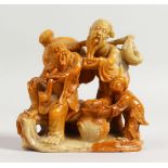 A 19TH CENTURY CHINESE CARVED SOAPSTONE GROUP of three figures. 3.5ins high.