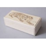 A GOOD JAPANESE MEIJI PERIOD CARVED IVORY LIDDED BOX OF A LION, 3cm high x 10cm wide x 4.5cm deep.