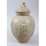 A CHINESE LONGQUAN CELADON CRACKLE GLAZE JAR & COVER, with moulded panels of immortals, the lid with