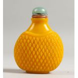 A CHINESE YELLOW JADE SNUFF BOTTLE AND STOPPER.