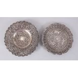 TWO 19TH CENTURY INDIAN FINELY CHASED SILVER CIRCULAR DISHES, 16cm diameter.