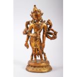 A 19TH-20TH CENTURY GILT BRONZE FIGURE OF AN EASTERN EIGHT-ARMED DEITY, 19cm high.