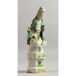 A SMALL 18TH CENTUR FIGURE OF GUANYIN seated on a throne. 6ins high.
