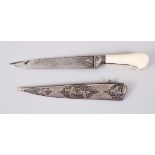 A 19TH CENTURY INDIAN DAGGER with ivory handle and silver inlaid sheath, 25cm long.