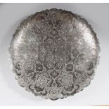 A PERSIAN ISPHAHAN WHITE METAL ENGRAVED DISH on three ball feet, 24cm diameter.