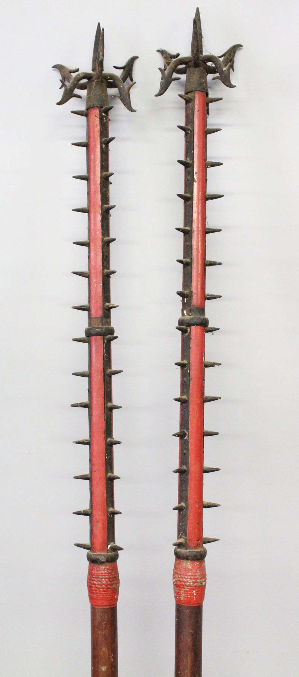 A GOOD PAIR OF ORIENTAL POLE ARMS, the tops with spikes and hooks, the collar formed from carved