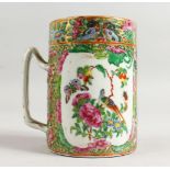 A GOOD CANTON MUG with panels of birds, flowers and figures. 5ins high.