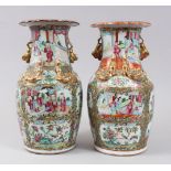A PAIR OF 19TH CENTURY CHINESE CANTON FAMILLE ROSE VASES, decorated with panels of figures within
