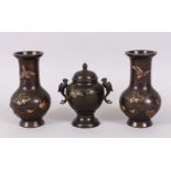 A GOOD GARNITURE OF JAPANESE BRONZE AND MIXED METAL, consisting of a pair of vases and a koro, all