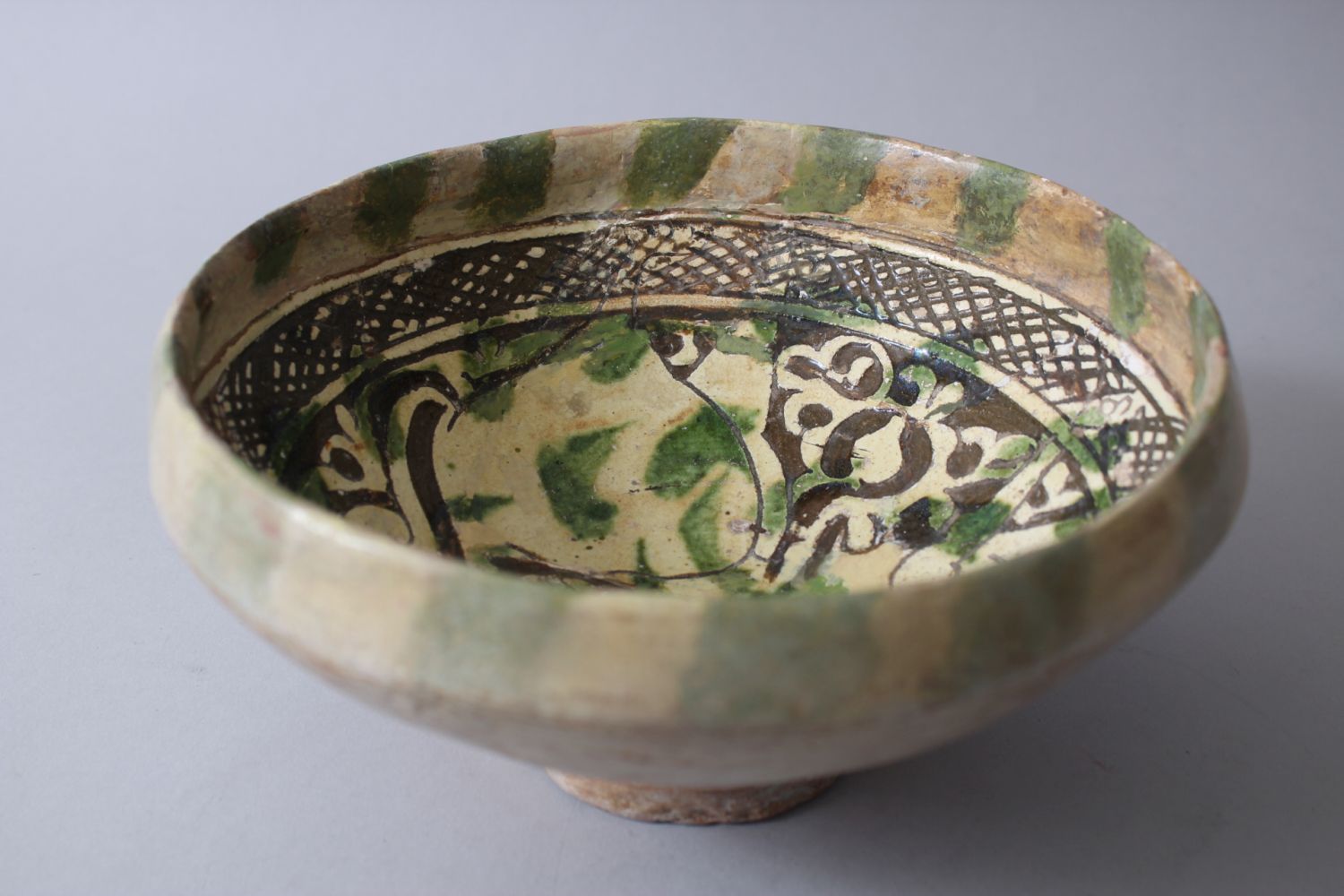 A 12TH-13TH CENTURY GARUS GLAZED POTTERY BOWL bearing a rams image amongst foliage. - Image 3 of 6