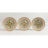 A SET OF THREE CANTON CIRCULAR PLATES pierced, with flowers. 6ins diameter.