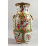 A 19TH CENTURY CANTON VASE with panels of figures, birds. butterflies and flowers, with four gilt