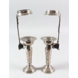 A VERY FINE PAIR OF PERSIAN QAJAR WHITE METAL CANDLESTICKS, 19cm high with holders.