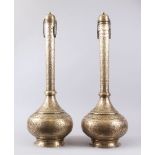 A GOOD PAIR OF 19TH CENTURY PERSIAN QAJAR HAND CHASED BRASS TALL BOTTLE VASES