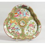 A GOOD CANTON CLOVER SHAPED DISH decorated with three panels of figures, birds, butterflies and