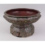 A LARGE 19TH CENTURY THAI MOTHER OF PEARL INLAID LACQUERED TWELVE SIDED PEDESTAL BOWL, 36cm diameter