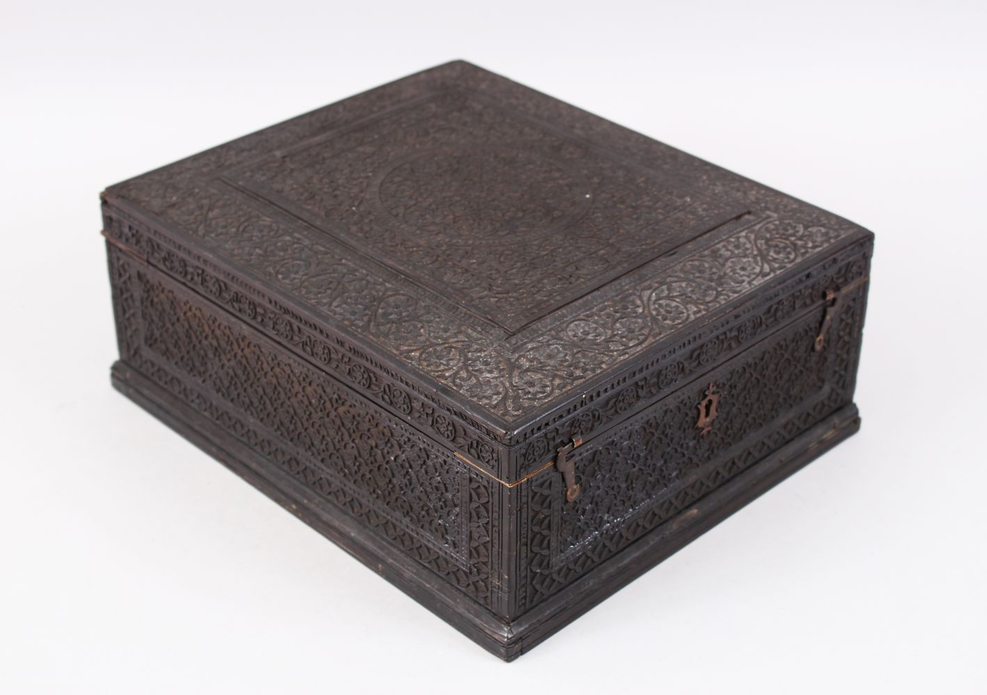 A 19TH CENTURY NORTH INDIAN CARVED EBONY JEWELLERY BOX with hinged lid and fitted interior, 30cm