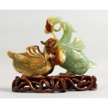 A GOOD 19TH CENTURY JADE GROUP OF TWO DUCKS on a pierced wooden stand. 7ins long.