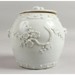 A CHINESE CELADON POT AND COVER with prunus blossom. 5.5ins high.
