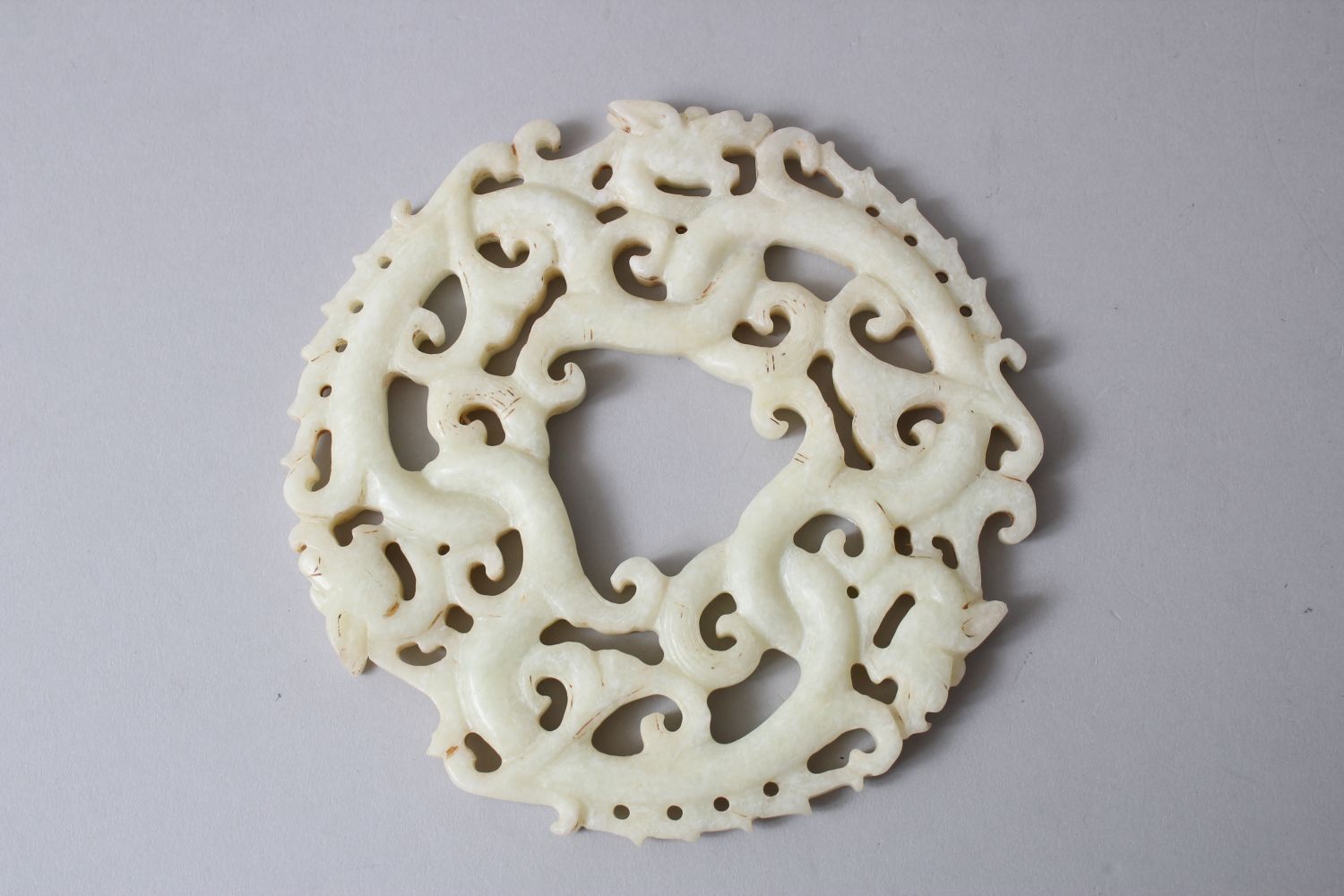 A GOOD CHINESE 19TH / 20TH CENTURY CARVED WHITE JADE ROUNDEL / BI DISK, carved to depict intertwined - Image 2 of 2