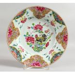 AN 18TH CENTURY CHINESE FAMILLE ROSE PLATE painted with flowers. 9ins diameter.