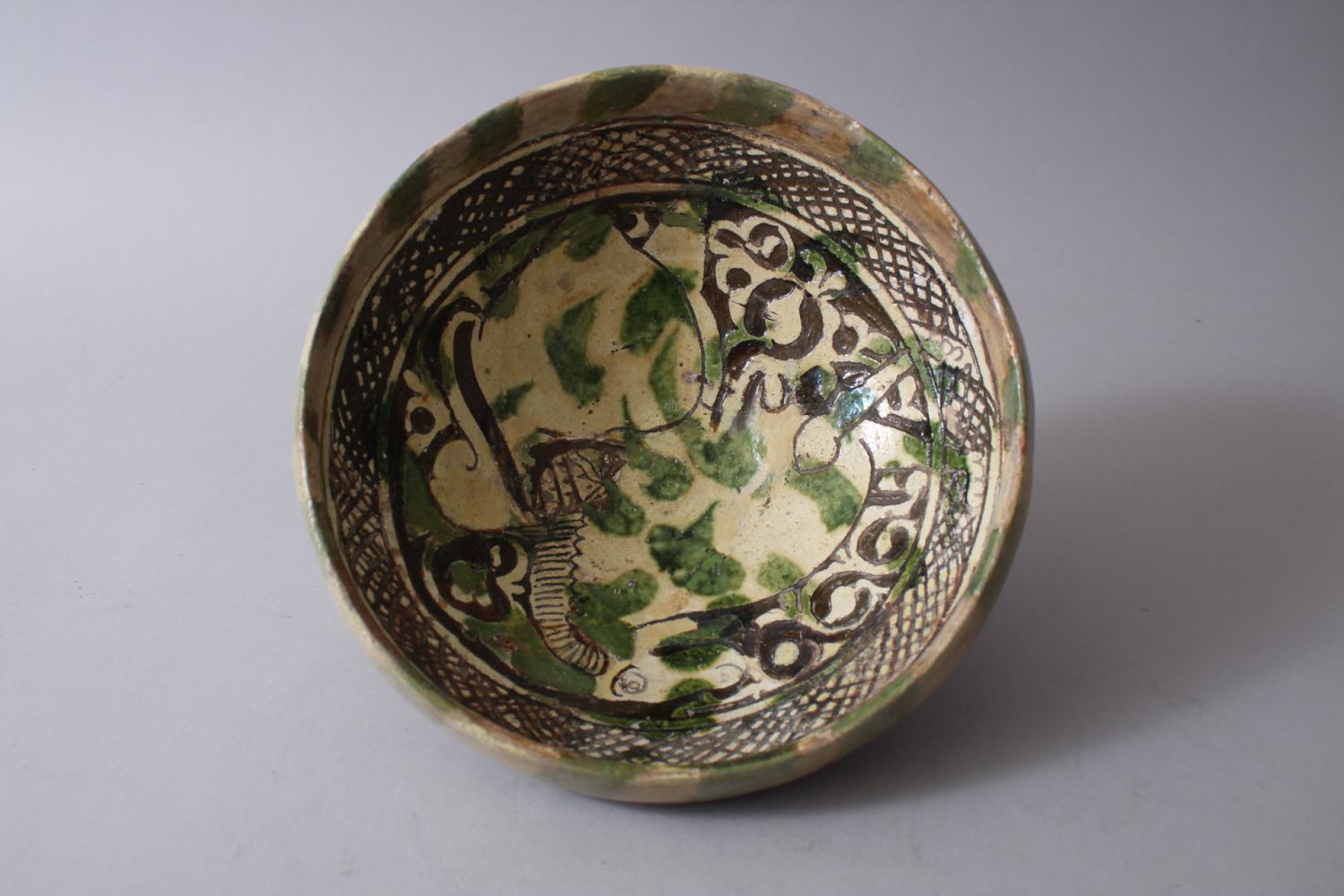 A 12TH-13TH CENTURY GARUS GLAZED POTTERY BOWL bearing a rams image amongst foliage. - Image 4 of 6