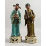 A PAIR OF 19TH CENTURY CHINESE POTTERY SCHOLARS. 15ins high.