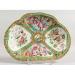 A CANTON OVAL DISH with four panels of birds, butterflies and flowers. 10ins wide.