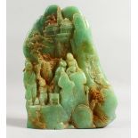 A CARVED GREEN STONE GROUP with four figures. 8.5ins high.