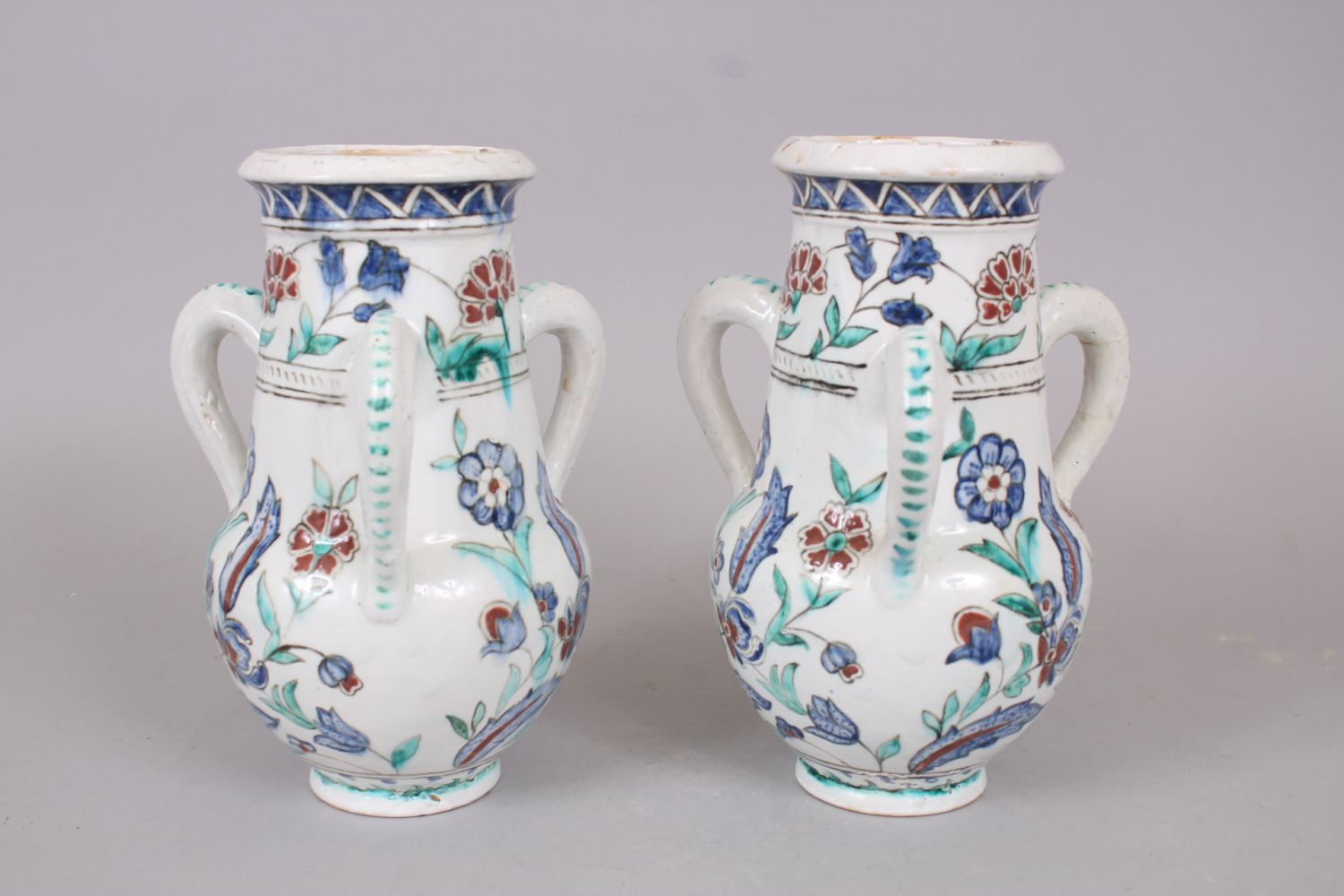 A PAIR OF IZNIK STYLE POTTERY THREE HANDLED VASES, 25cm high. - Image 3 of 4