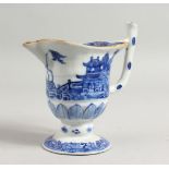 A CHINESE BLUE AND WHITE JUG with buildings, fence and trees. 5ins high.