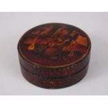 A 19TH CENTURY PERSIAN QAJAR LAQUER CIRCULAR BOX AND COVER, the lid with a seated man with a guitar,