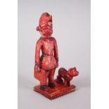 A RARE 18TH-19TH CENTURY INDIAN POLYCHROME IVORY FIGURE OF A MAN carrying a Union flag, a dog by his