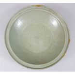 A GOOD CHINESE 15TH CENTURY MING DYNASTY CELADON LONGQUAN MOULDED PORCELAIN DISH, the interior