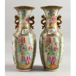 A PAIR OF 19TH CENTURY CANTON VASES painted with four panels of figures, flowers, birds and insects.