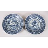 A PAIR OF CHINESE BLUE & WHITE KRAAK PORCELAIN PLATES, with decoration of dragons amongst waves, and