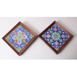 TWO PERSIAN QAJAR FRAMED POTTERY TILES.