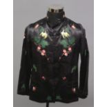 A 20TH CENTURY CHINESE BLACK GROUND LADY'S SILK JACKET, embroidered to the front with a mirrored