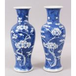 A PAIR OF LATE 19TH CENTURY CHINESE BLUE & WHITE PRUNUS PORCELAIN VASES, of baluster form, 25cm