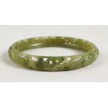 A CHINESE CARVED JADE BANGLE.