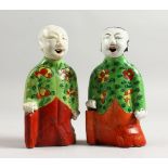 A GOOD PAIR OF 18TH CENTURY CHINESE FAMILLE ROSE FIGURES of boys, three quarter length. 6ins high.