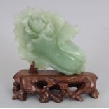 A 20TH CENTURY CHINESE CELADON BOWENITE HARDSTONE CARVING OF A LOTUS FLOWER, together with a