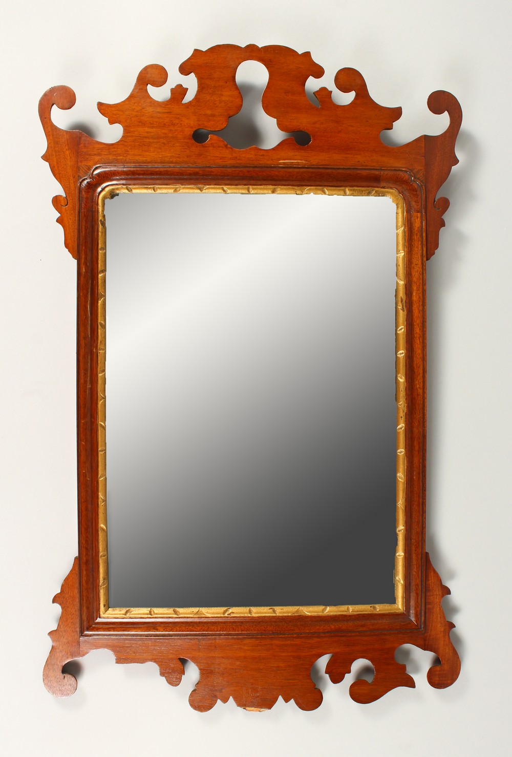 A GEORGE III STYLE MAHOGANY FRETWORK FRAMED WALL MIRROR. 70cms high x 44cms wide.