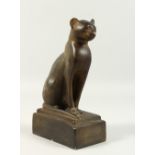AN EGYPTIAN STYLE PLASTER MODEL OF A SEATED CAT. 20cms high.